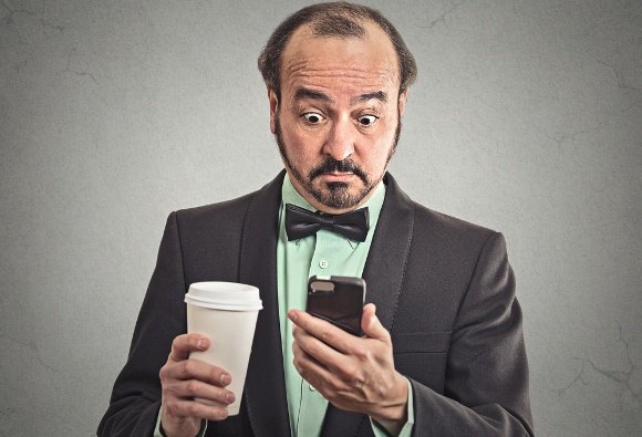 businessman-drinking-coffee-looking-at-phone